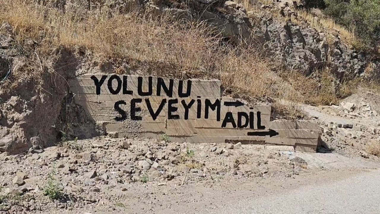 İzmir'in Dikili ilçesinde yıllardır asfaltlanmayan yol vatandaşları duvarlara yazdırdı