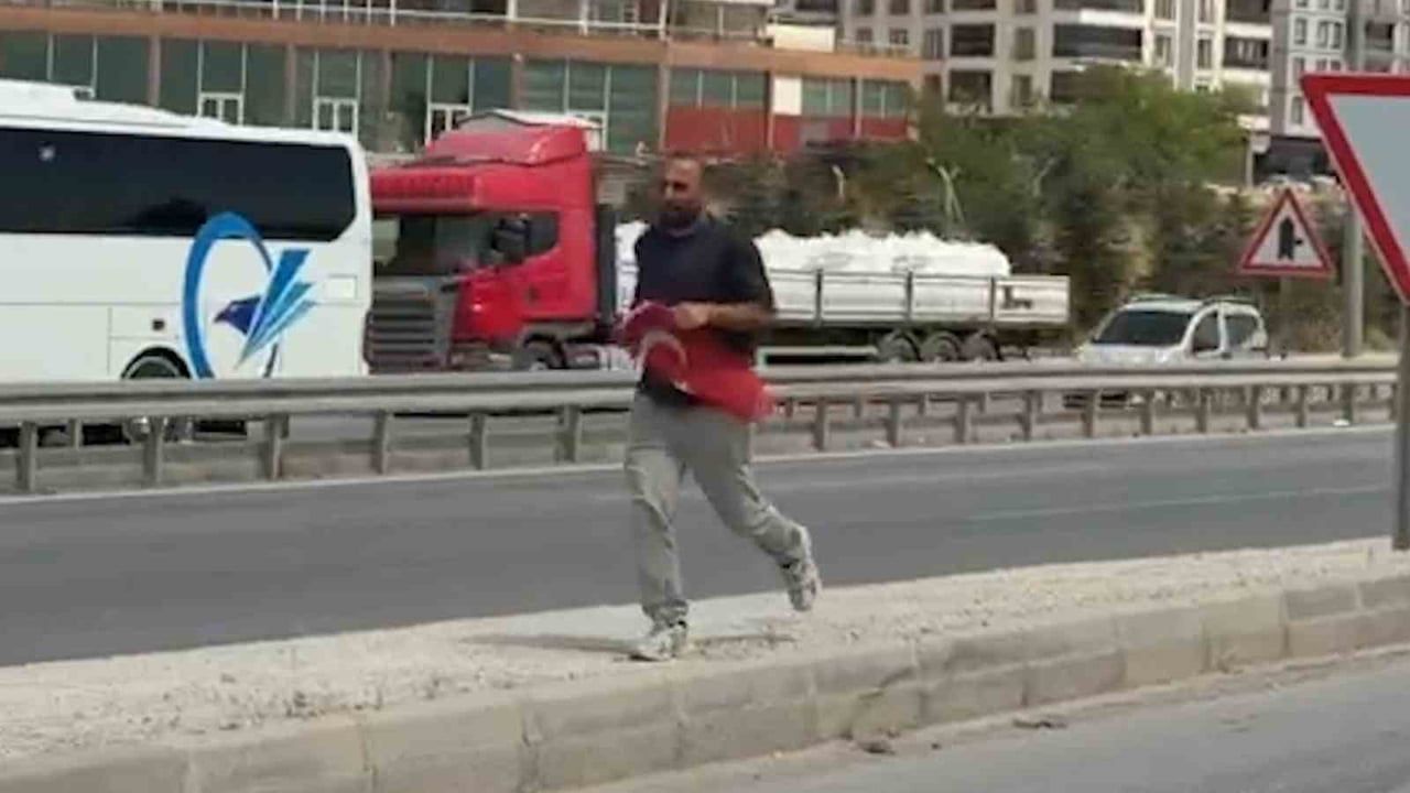 Karayolunda yatan Türk bayrağını durup alan duyarlı vatandaş