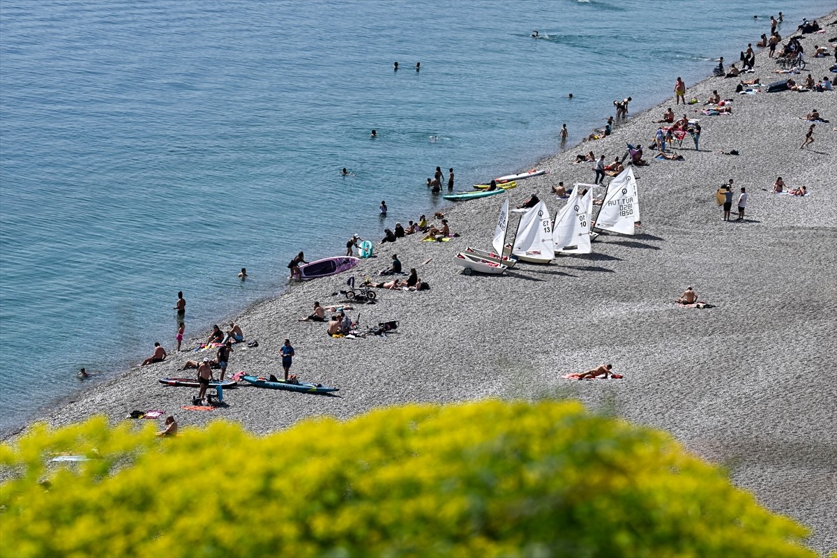 Antalya'da güneşli havayı değerlendirmek isteyen kent sakinleri ve turistler sahillerde yoğunluk...