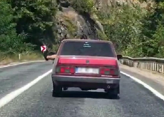 KARABÜK'TE BİR SÜRÜCÜ OTOMOBİLİN CAMINDAN AYAKLARINI DIŞARIYA ÇIKARARAK SEYAHAT EDEREK, TRAFİĞİ...
